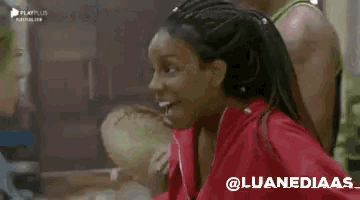 a woman in a red jacket is making a funny face while standing next to a group of people .