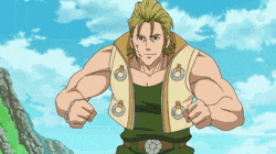 a man in a green vest is standing with his arms outstretched in front of a mountain .