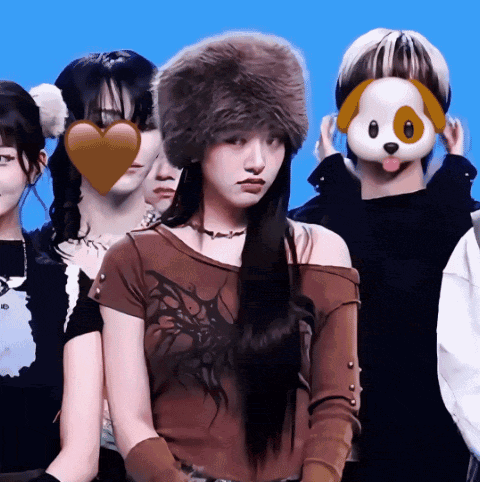 a woman wearing a fur hat stands in front of a group of people