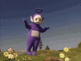 a purple teddy bear from the teletubbies is dancing in a field of flowers .