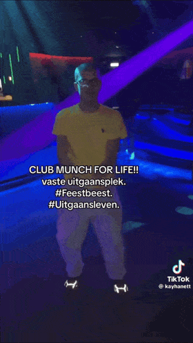 a man in a yellow shirt is dancing in a club with a caption that reads club munch for life