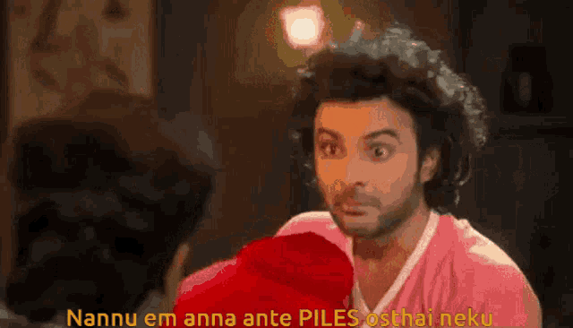 a man in a pink shirt says nannu em anna ante piles osthali neku