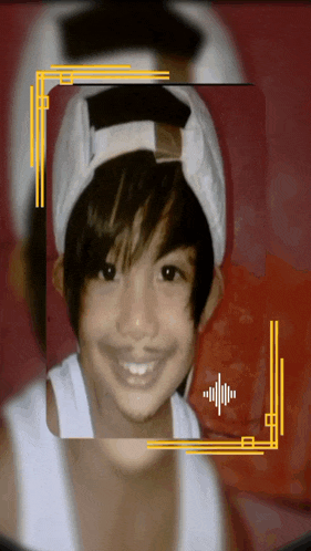 a young boy wearing a white hat and a white tank top smiles