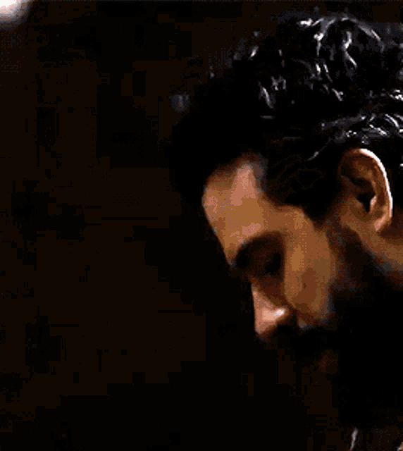 a man with a beard is wearing a black jacket