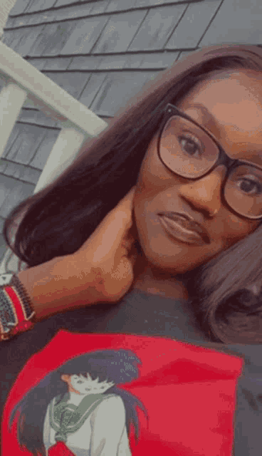 a woman wearing glasses and a t-shirt with a girl on it