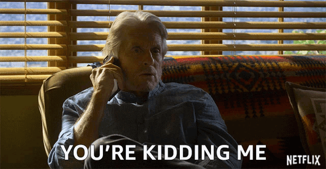 an older man sitting on a couch talking on a cell phone with the words you 're kidding me netflix