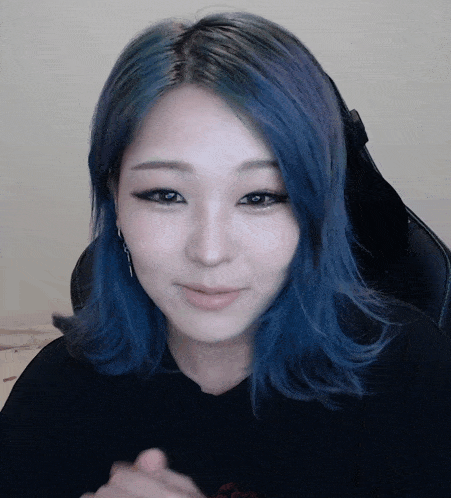 a girl with blue hair is wearing a black shirt that says ' snoop dogg ' on it