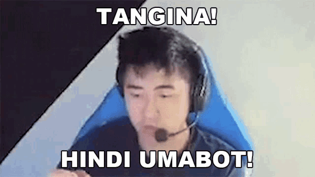 a man wearing headphones and a microphone is sitting in a chair with a caption .