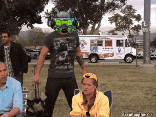 a man wearing a mask stands in front of a ice cream truck