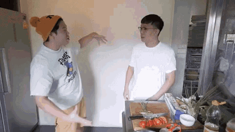a man wearing a shirt that says panic on it is talking to another man