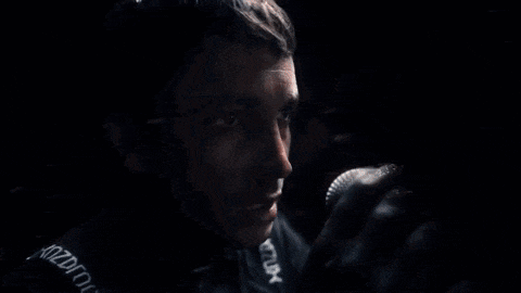 a man is speaking into a microphone in a dark room .