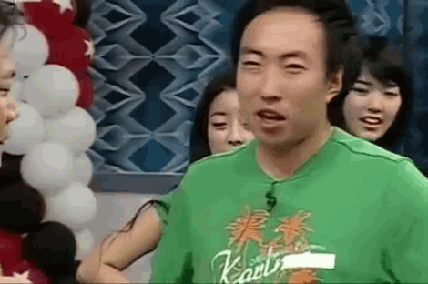 a man wearing a green shirt with karl on it