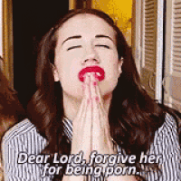 a woman with red lips is praying with her hands folded and says dear lord forgive her for being porn