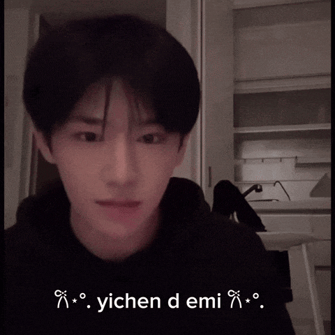 a young man in a black shirt says " yichen demi " in white letters