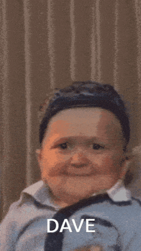 a baby wearing a hat and tie with the name dave on the bottom right