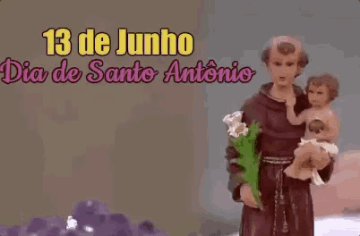 a statue of a man holding a baby with the date 13 de junho on it