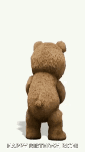 a teddy bear is holding a shaker and dancing .