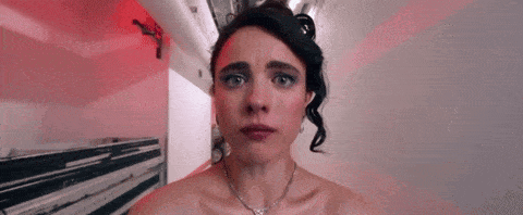 a woman without a shirt is looking at the camera