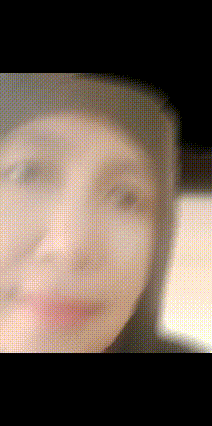a blurry picture of a person 's face with a hat on .