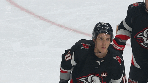 a hockey player wearing a jersey with a bull on it