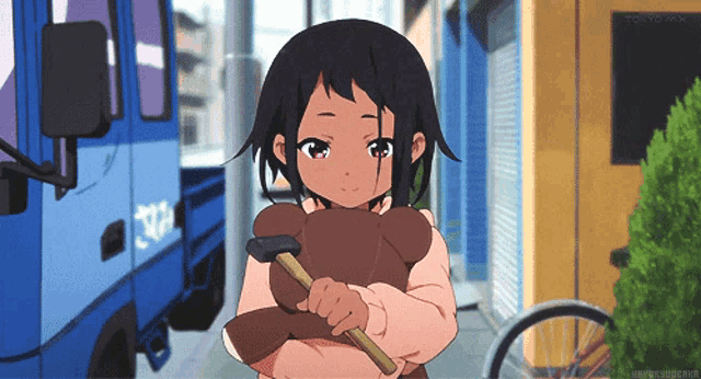 a girl holding a hammer in front of a blue truck