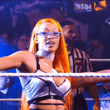 a woman in a wrestling ring with the name tiffany written below her