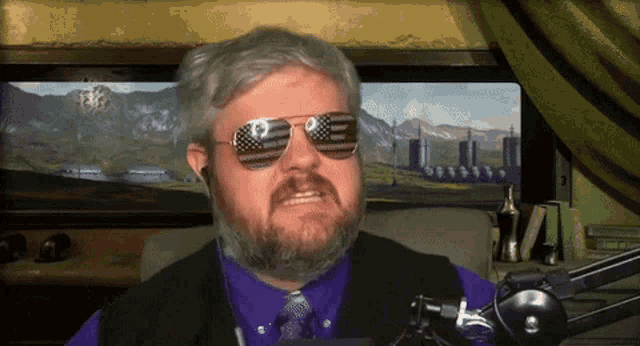a man with a beard wearing sunglasses with an american flag design