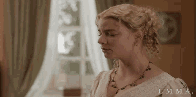 a woman in a white dress with the name emma on the bottom right