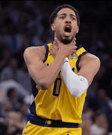 a basketball player with the number 0 on his jersey is holding his neck
