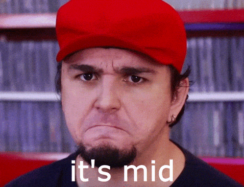 a man wearing a red hat with the words it 's mid on the bottom
