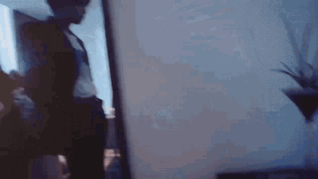 a blurry picture of a person standing in front of a mirror in a dark room .