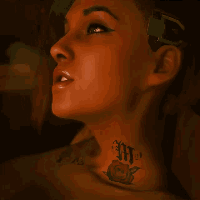 a woman has a tattoo on her neck that says ' ht '