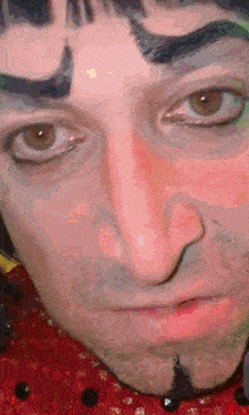 a close up of a man 's face with a beard and eyebrows