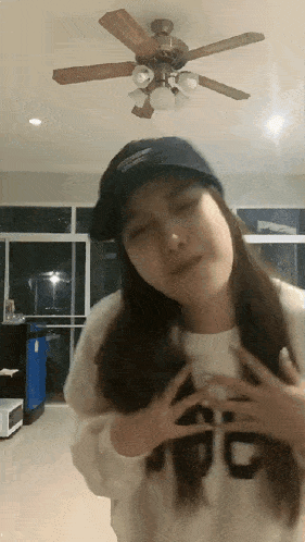 a woman wearing a hat and a sweater with the letter g on it