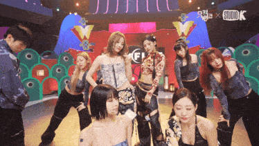 a group of female dancers on a stage with the studio k logo in the background