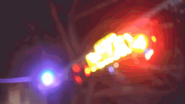 a blurred image of a red and yellow sign that says ' snc ' on it