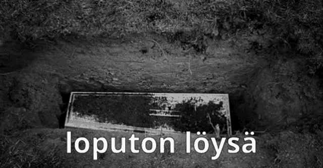 a black and white photo of a grave with the words loputon loysa written in white