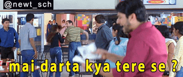 a man in a red shirt stands in front of a crowd of people with the caption mai darta kya tere se ?