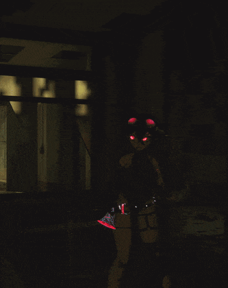 a cartoon character with red eyes is standing in the dark