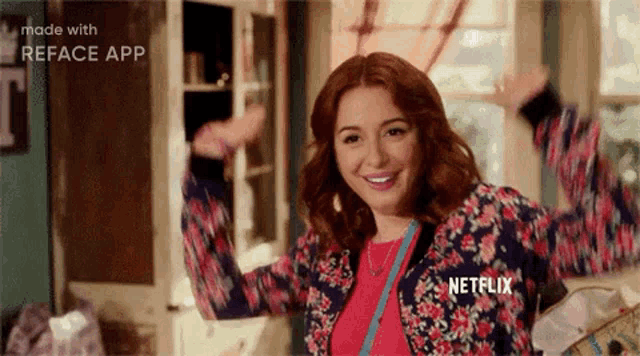 a woman is standing in a room with her arms in the air and smiling .