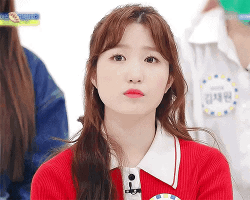a girl wearing a red sweater has a name tag that says ' a ' on it