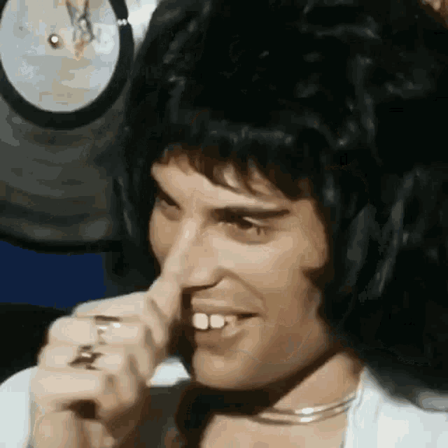 a close up of a person 's face with a wig on .