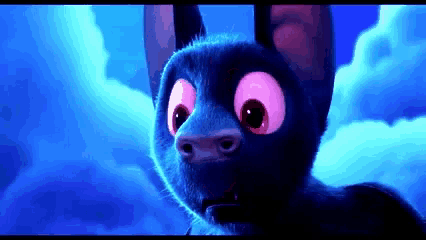 a close up of a cartoon bat with big pink eyes