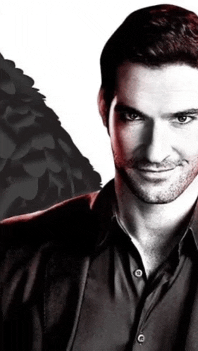 a man in a black shirt is smiling in front of a white background