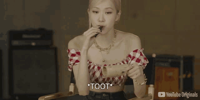 a woman is sitting in a chair eating a toot