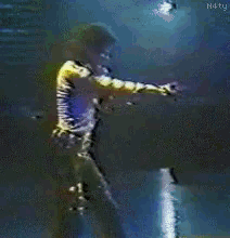 a man singing into a microphone with n4ty written on the bottom right