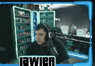 a man wearing headphones is sitting in front of a microphone in a room with a sign that says javier