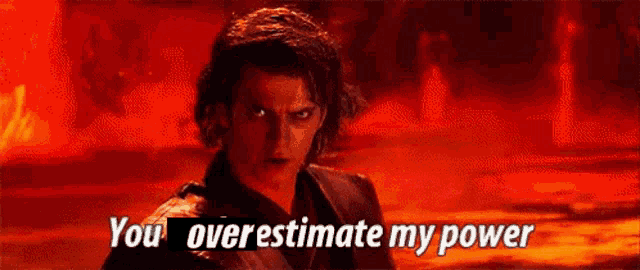 a man in a black suit is standing in front of a red background and says `` you overestimate my power '' .
