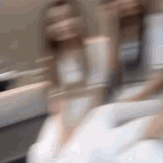 a blurry picture of two women standing next to each other in a bathroom .