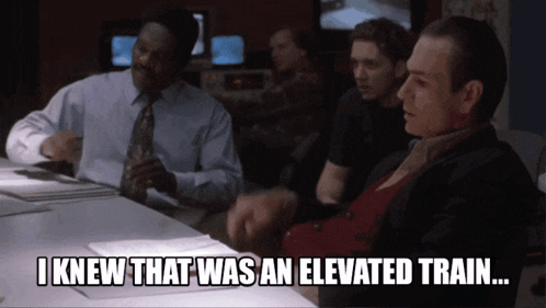 a man sitting at a table with the words i knew that was an elevated train
